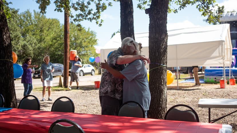 Helen embracing a community member, showing care and connection